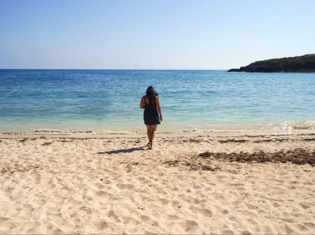 The author Vanessa Ramos, walking along the coast line on a sunny day