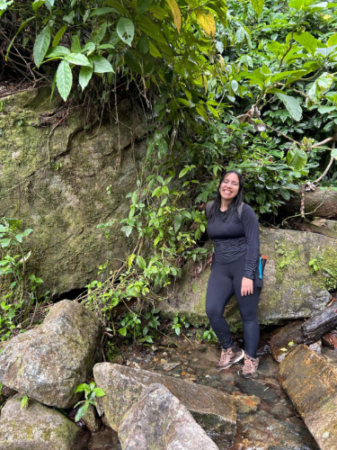 The author Vanessa Ramos, smiling for a photo along the trail in El Salto San Salvador