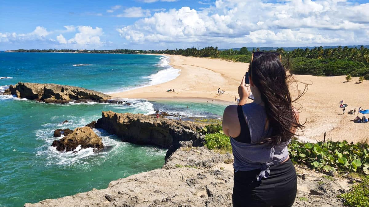 Travel Lemming writer Vanessa Ramos taking a photo of the overlooking view from La Poza del Obispo