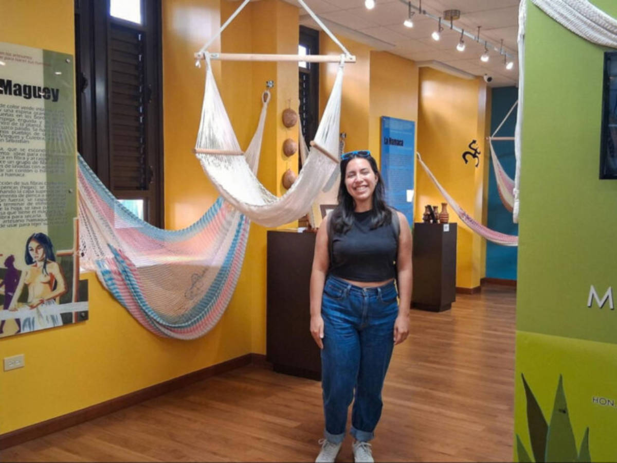 The author Vanessa Ramos, standing next to hammocks at the Museo de la Hamaca