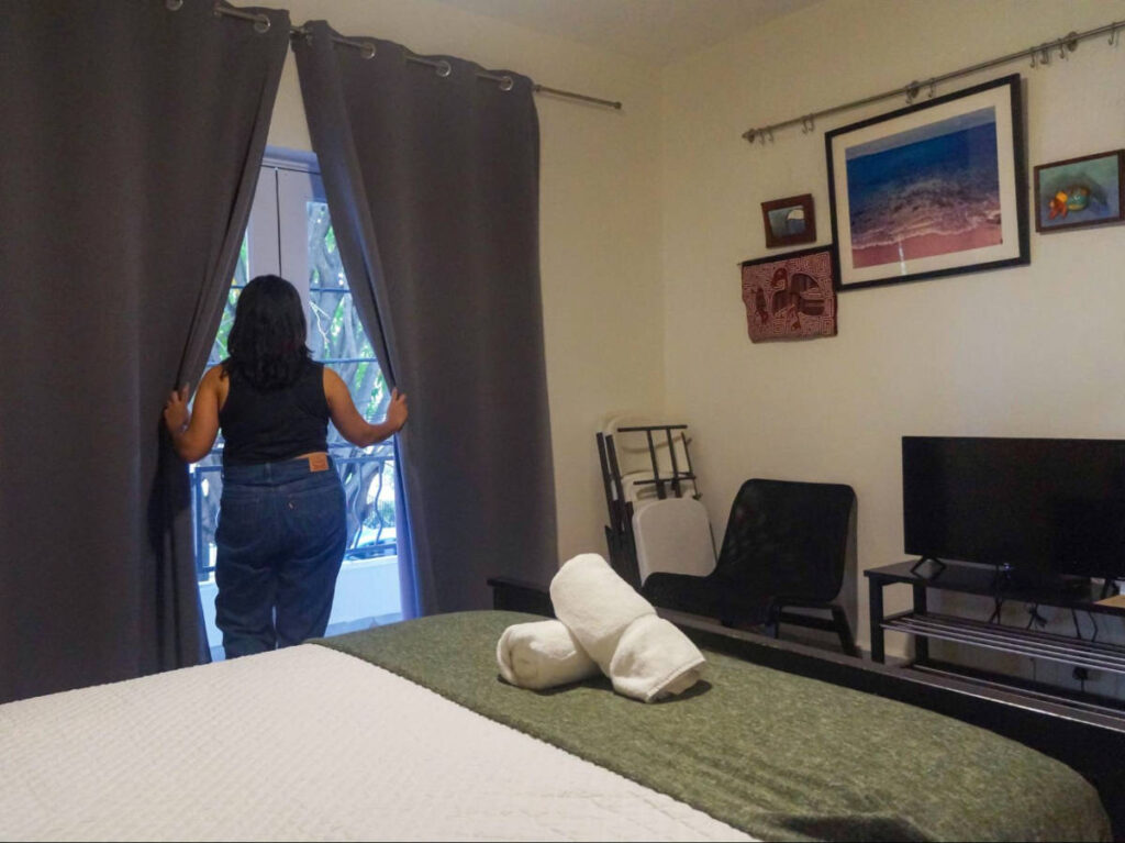 The author Vanessa Ramos, looking out at the window in Rincón Plaza Hotel room
