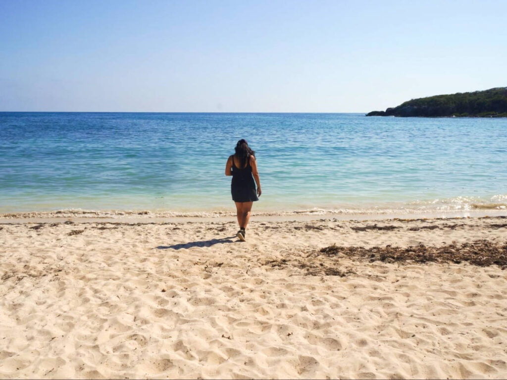 The author Vanessa Ramos walking along the shoreline of Vieques beach