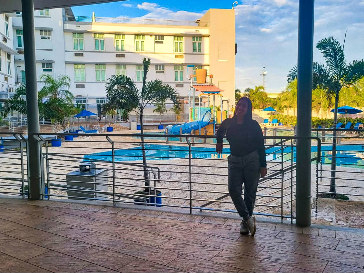 The author Vanessa Ramos, posing for a photo near the pool at the Courtyard by Marriott in Aguadilla