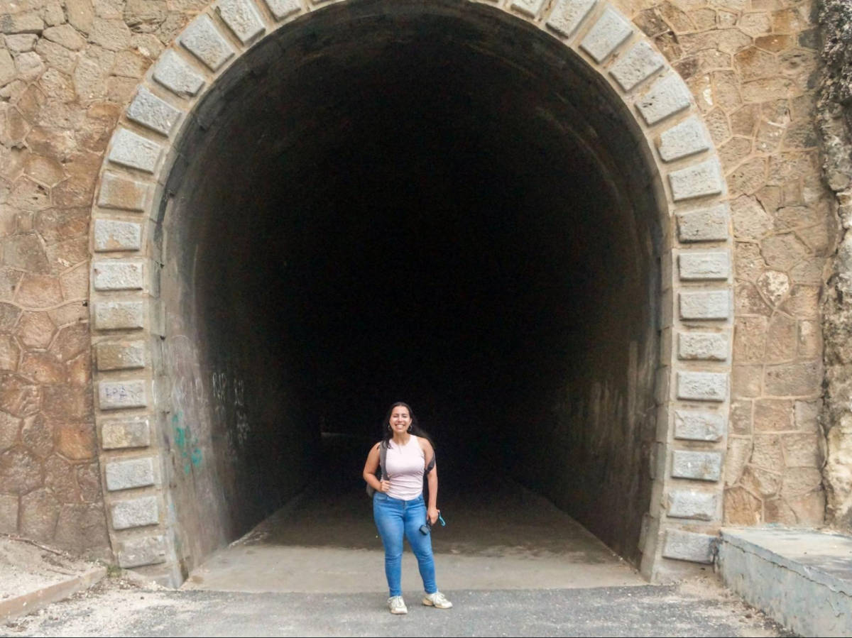 The author Vanessa Ramos, posing for a photo at the entrance of Guajataca Tunnel