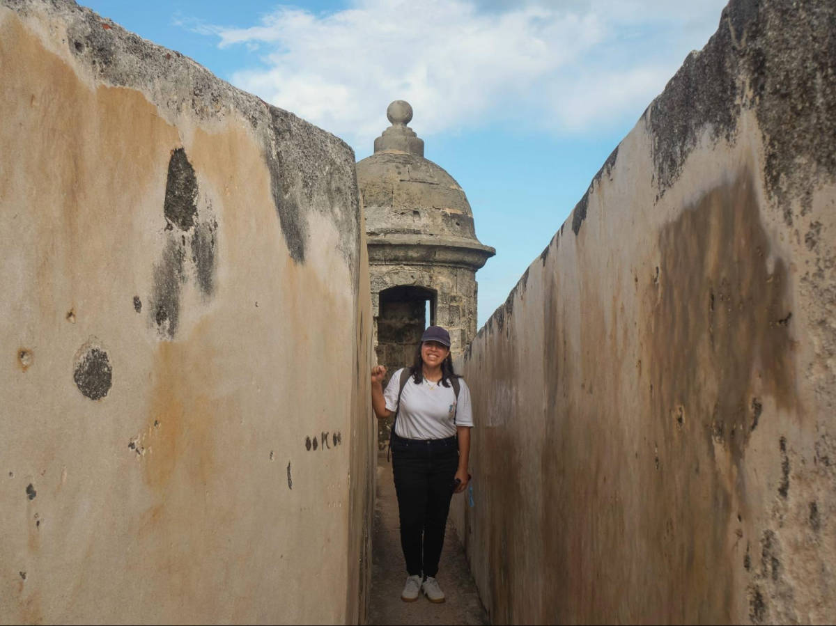 The author Vanessa Ramos, walking at one of the sentry boxes of the fort in Castillo San Cristobal