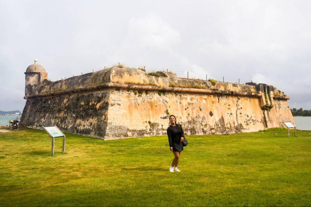 The author Vanessa Ramos, posing for a photo in front of the Isla de Cabras State Park