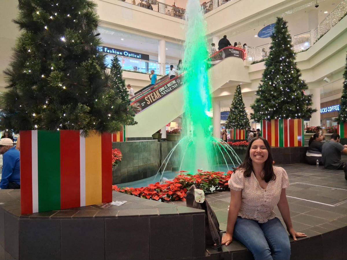 The author Vanessa Ramos, sitting inside Plaza Las Americas