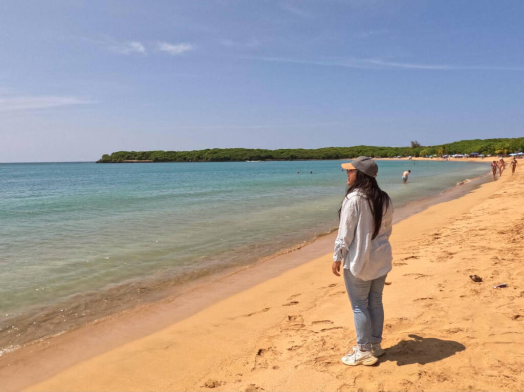 The author Vanessa Ramos, admiring the ocean from the Vacia Talega Beach on a sunny day
