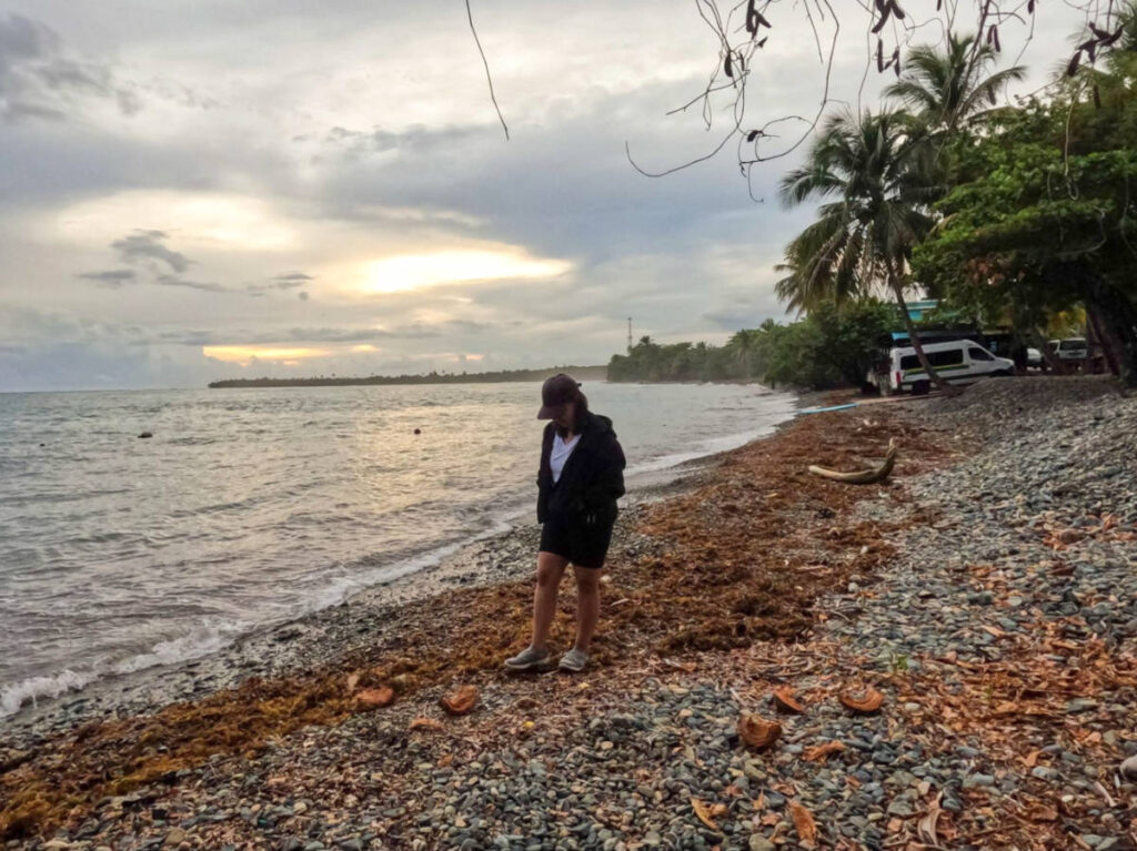 The author Vanessa Ramos, walking along the rocky Inches Beach