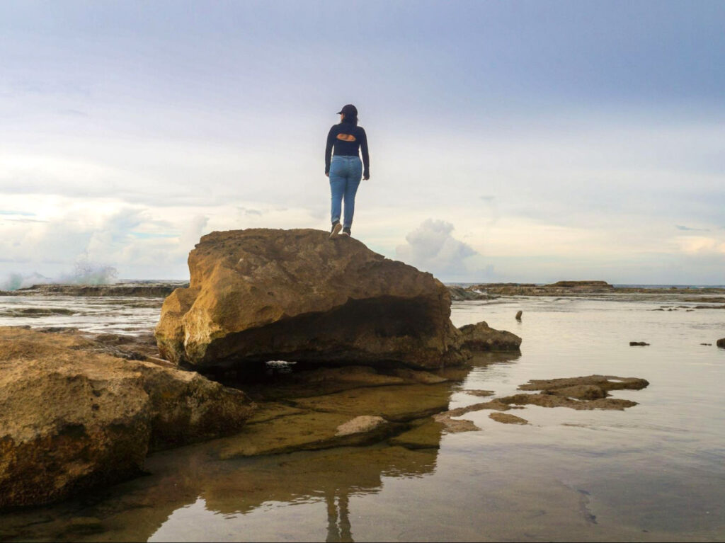 The author Vanessa Ramos, standing on top of the rock in Pocita de la Princesa