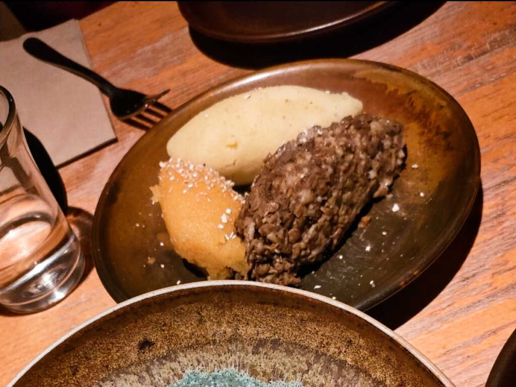 A plate with vegetarian haggis, turnips, and potatoes