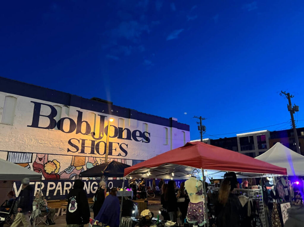 View of the vendors at the First Fridays at Crossroads Arts District at night