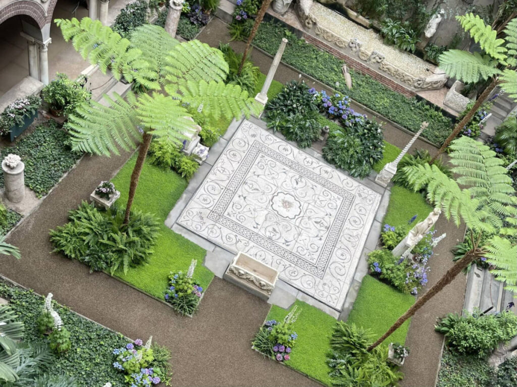 Aerial view of the Venetian-style courtyard surrounded by greenery in the Isabella Stewart Gardner Museum