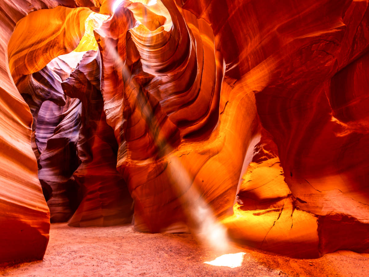 View of the sunray peeking through the unique and vibrant Antelope Canyon