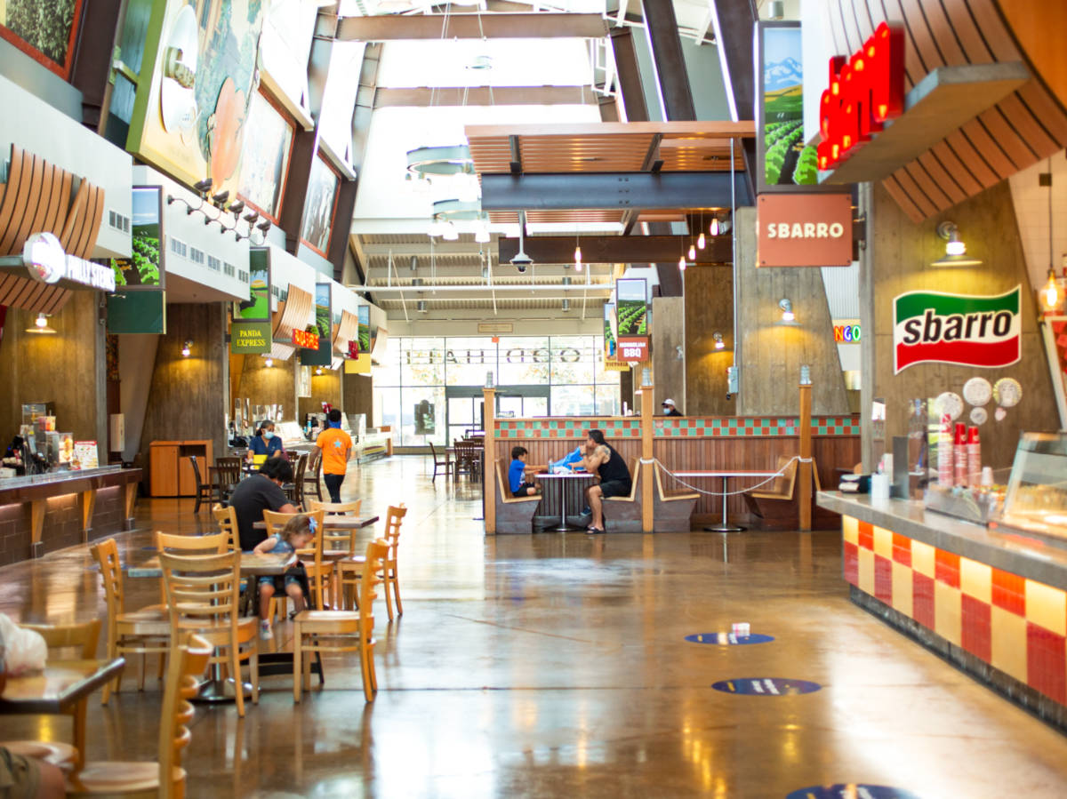 View of the food stalls and the people dining at the food court in Victoria Gardens Mall