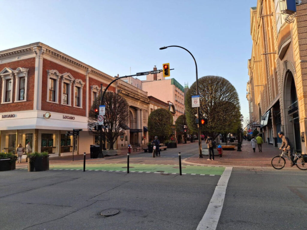 People cycling and walking around the Government Street at sunset