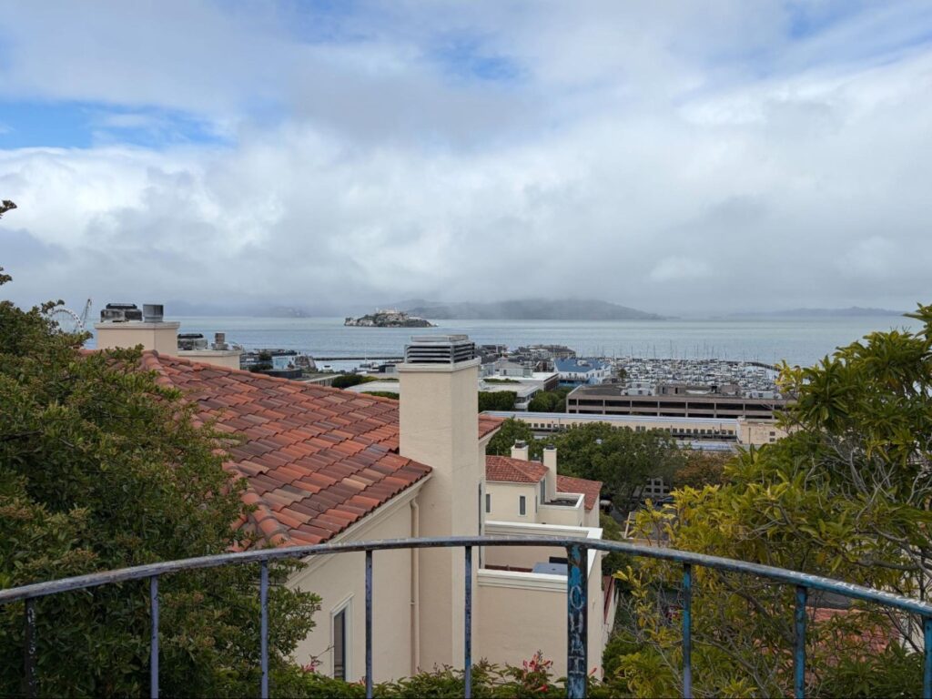 View from Jack Early Park on Telegraph Hill looking out over rooftops and San Francisco Bay, with Alcatraz Island visible
