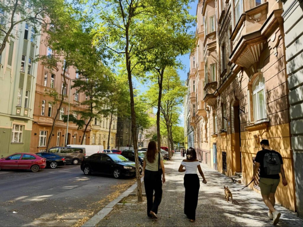 People walking along the tree-lined streets of Vinohrady