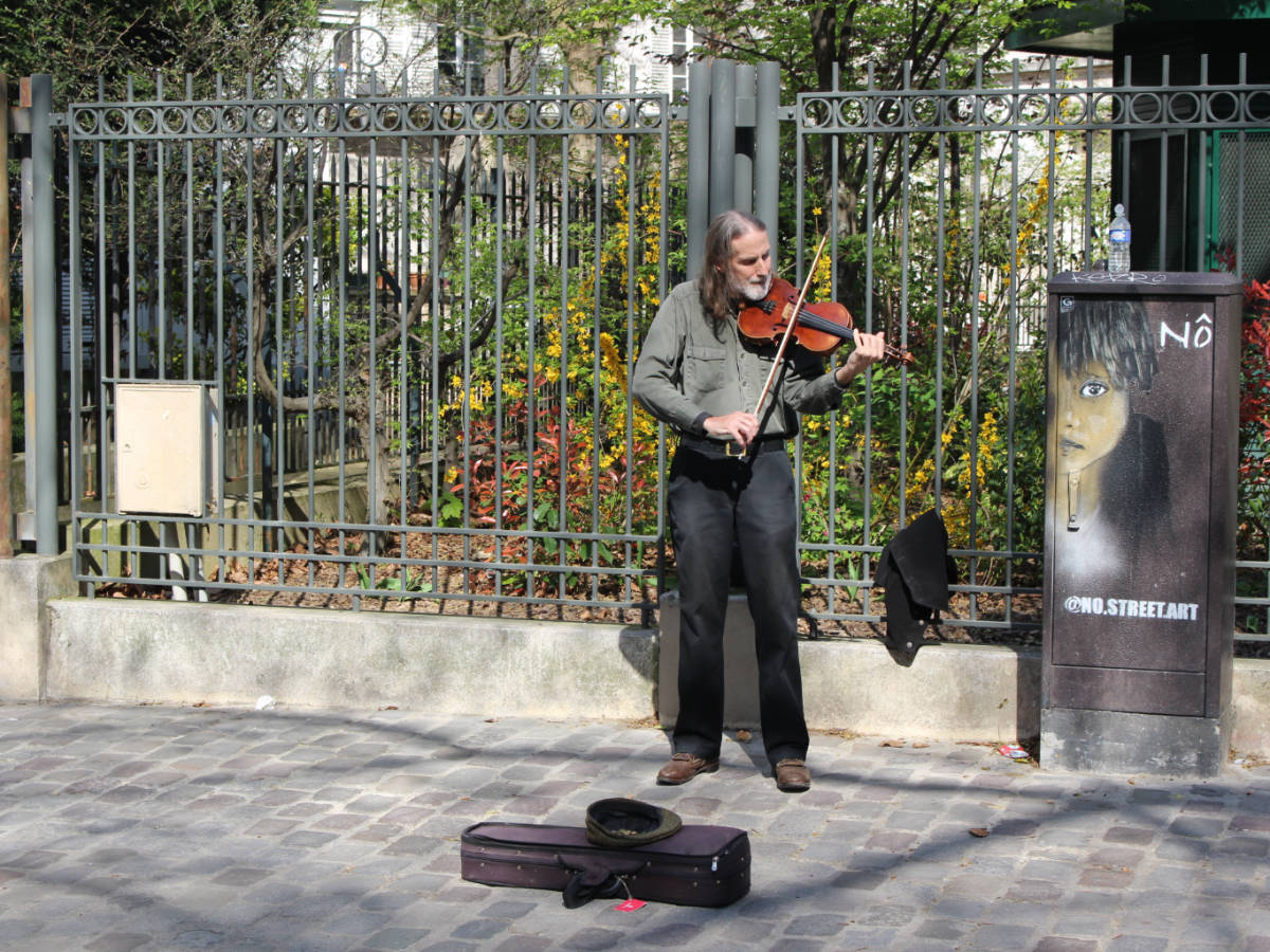 A violinist playing outside the Abbesses Métro station