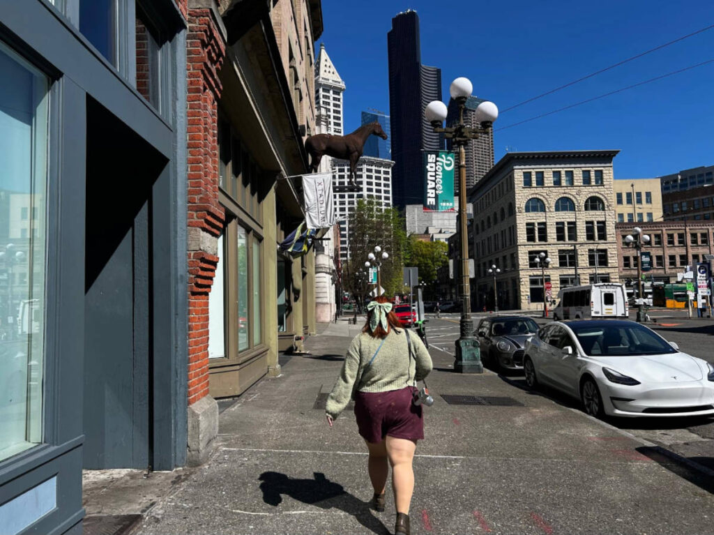 The author's friend walking at the Pioneer Square