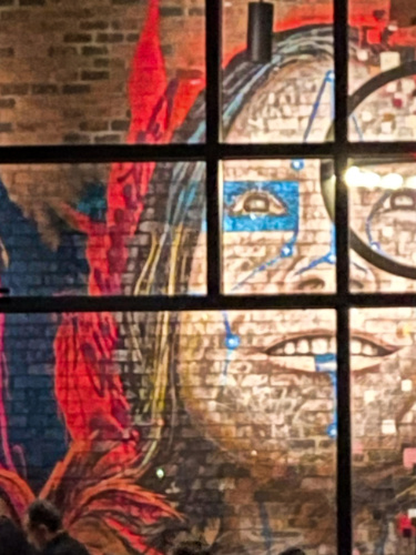 View of the mural of a woman's face on the wall inside the Warehouse 72
