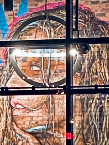 Mural of a woman's face on the wall inside the Warehouse 72