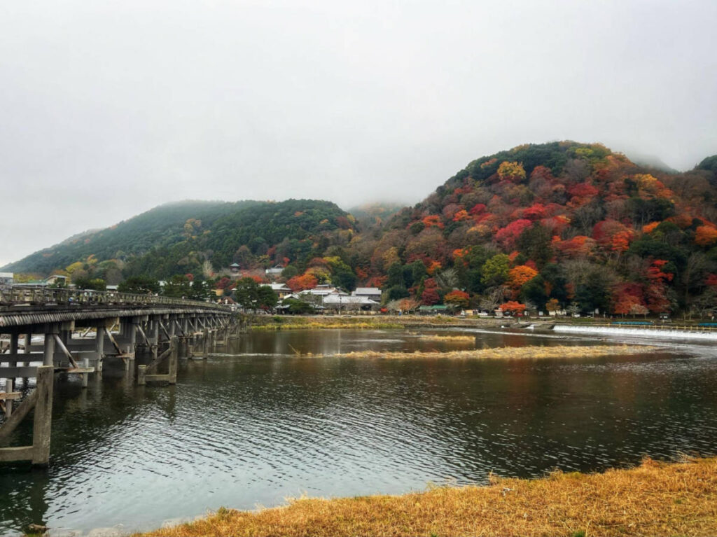 View of the fall foliage from the calm waters of the Katsuragawa