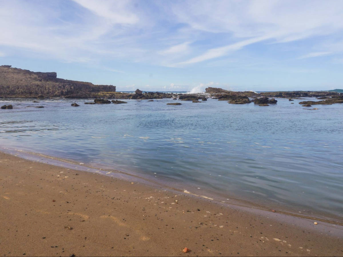 The waves seen on the back of the cove in Playa Sardinera