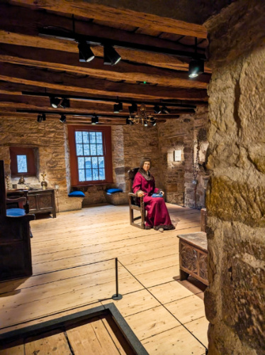 An eerie wax figure sitting on a chair inside the Provand’s Lordship
