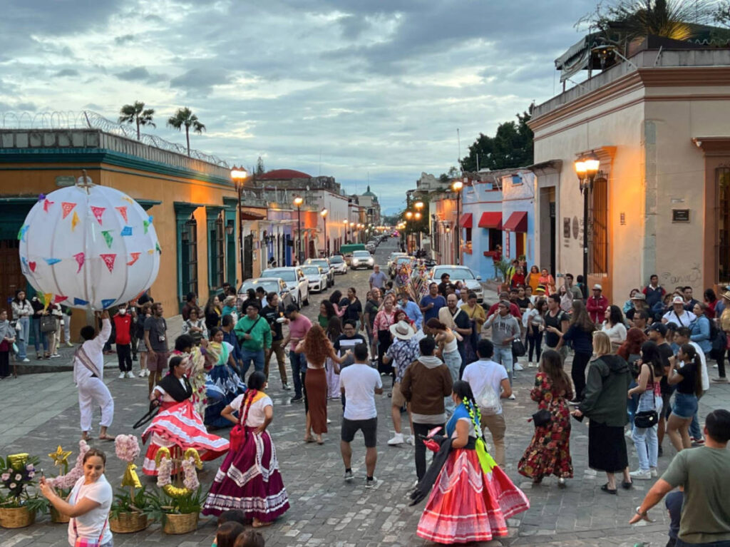 People celebrating in the middle of a street in Oaxaca City