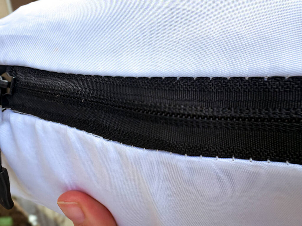 Closeup look of the threads around the zipper of the compressed packing cube