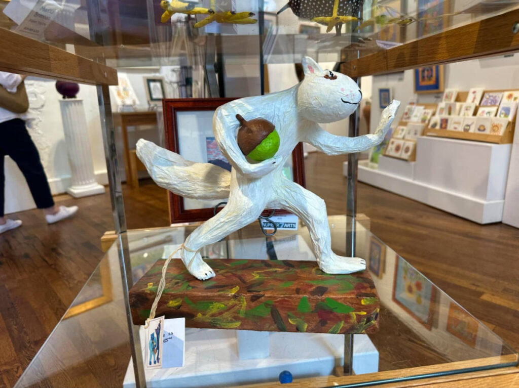 A white squirrel sculpture on display