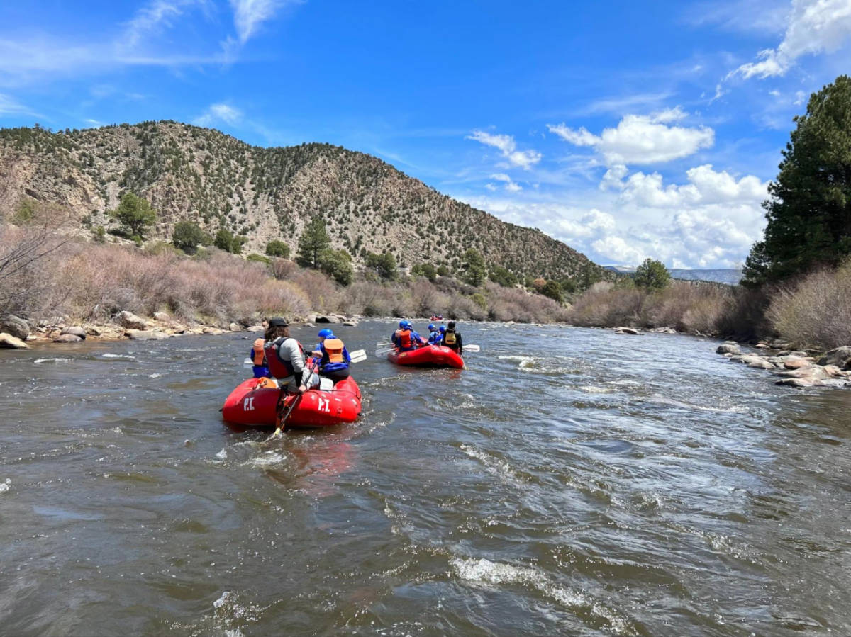 People on a whitewater rafting with scenic views