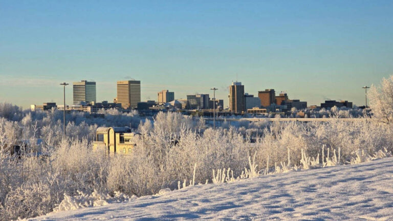 Panoramic view of the Anchorage skyline and the snow covered roads in winter