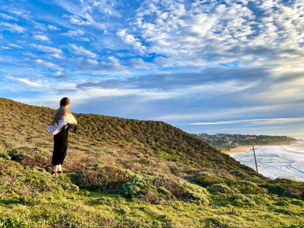 A woman admiring the Pacific Beach from the surrounding hills