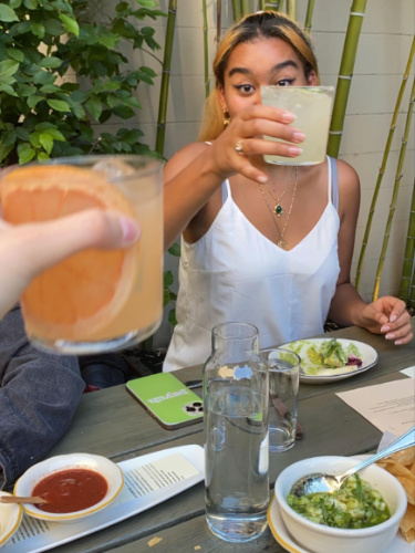 The author's friend clinking glasses at Comal