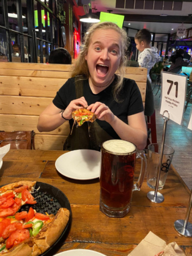 The author's friend eating and drinking a pitcher of beer