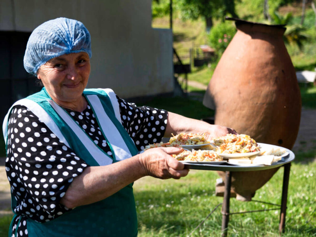 A woman serving a tray with Georgian foods