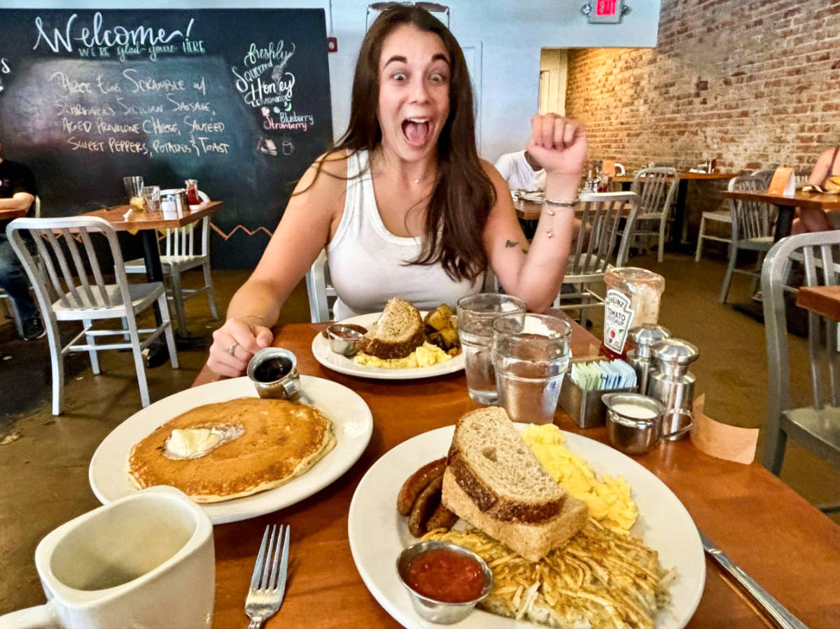 A woman excited to eat the foods from Matt’s Big Breakfast