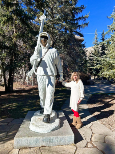 The author Abigail Bliss's mother-in-law, posing with the with the 10th Mountain Division sculpture