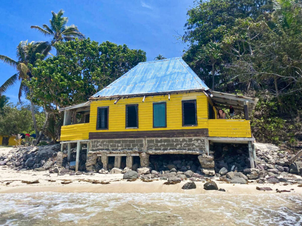 Façade of the yellow cottage along the shoreline