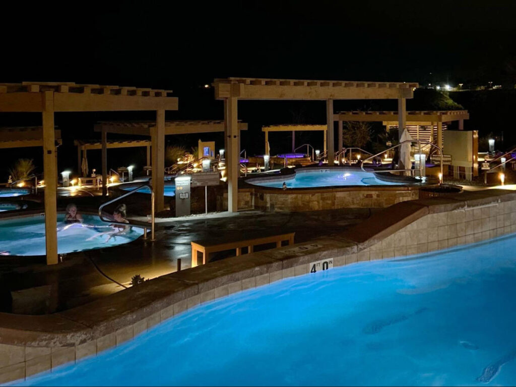The people lounging on the pools in Zion Canyon Hot Springs at night