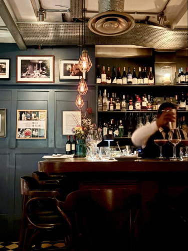 View of the interior and the bartender mixing drinks in Zoilo