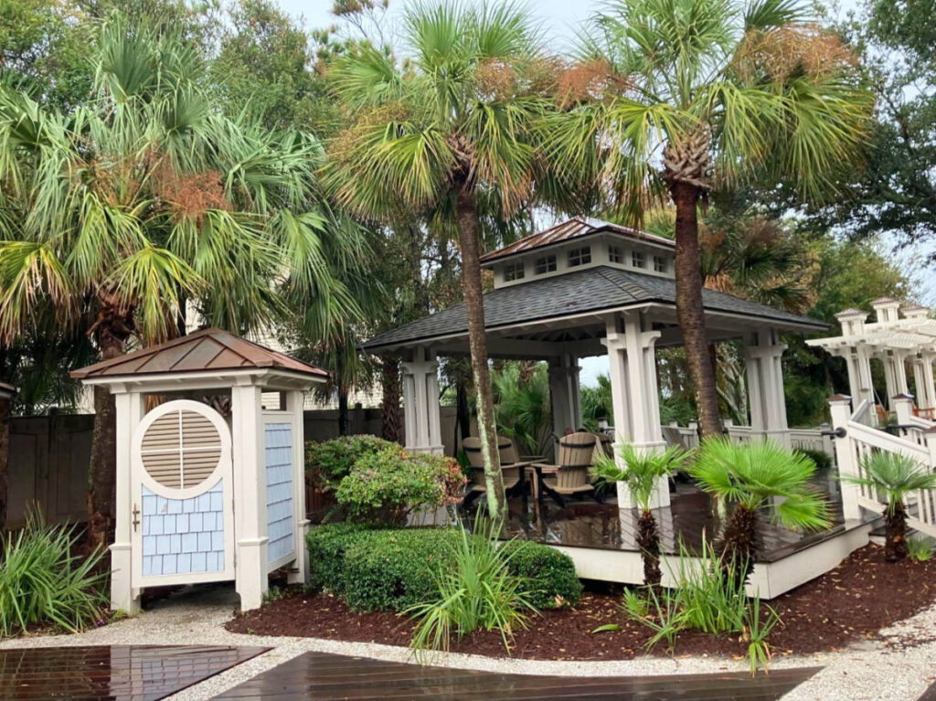 A tropical gazebo with palm trees and a pavilion at Coligny Beach park