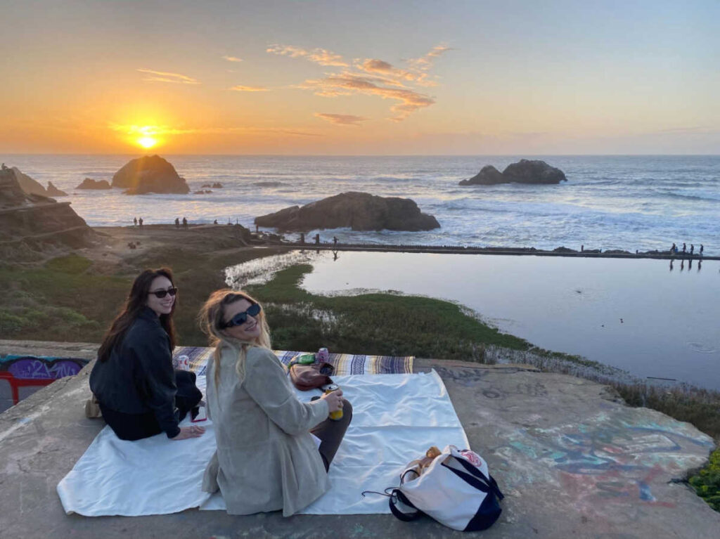 The author's friends enjoying the scenic sunset views at Lands End Lookout